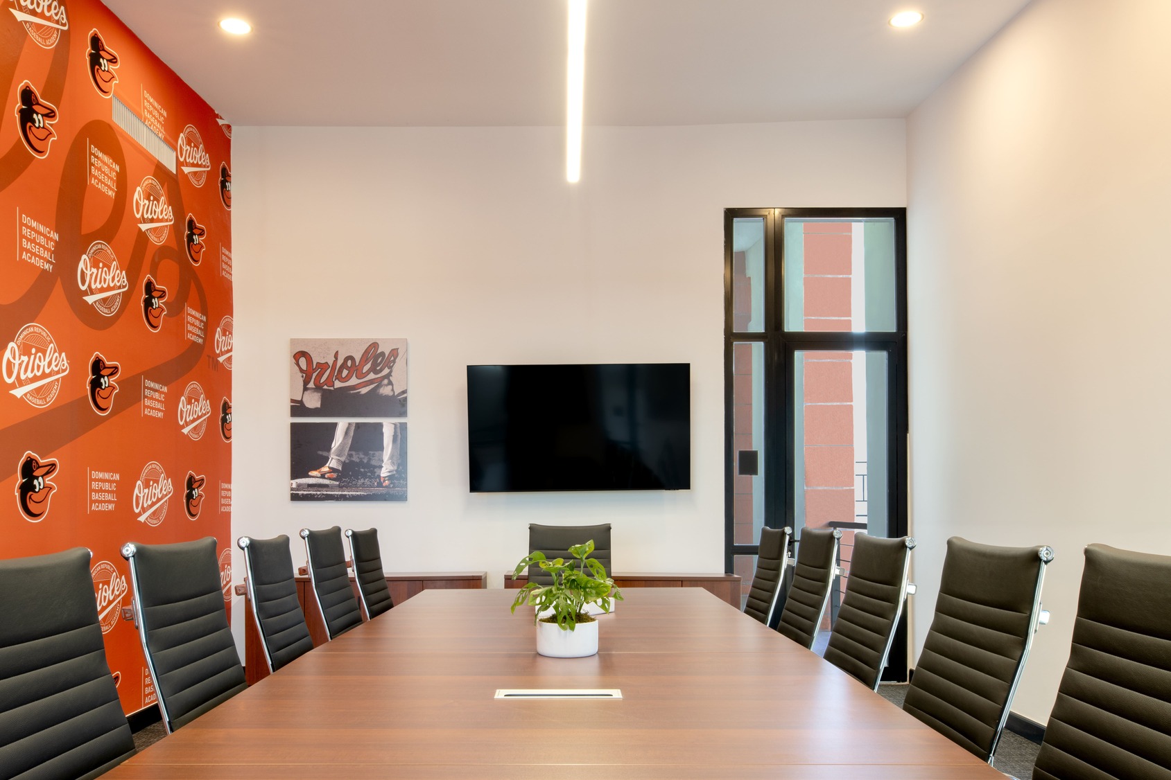 Modern office space with red ergonomic chairs and white desks